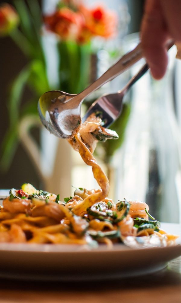 A vertical shot of delicious pasta in a white plate
